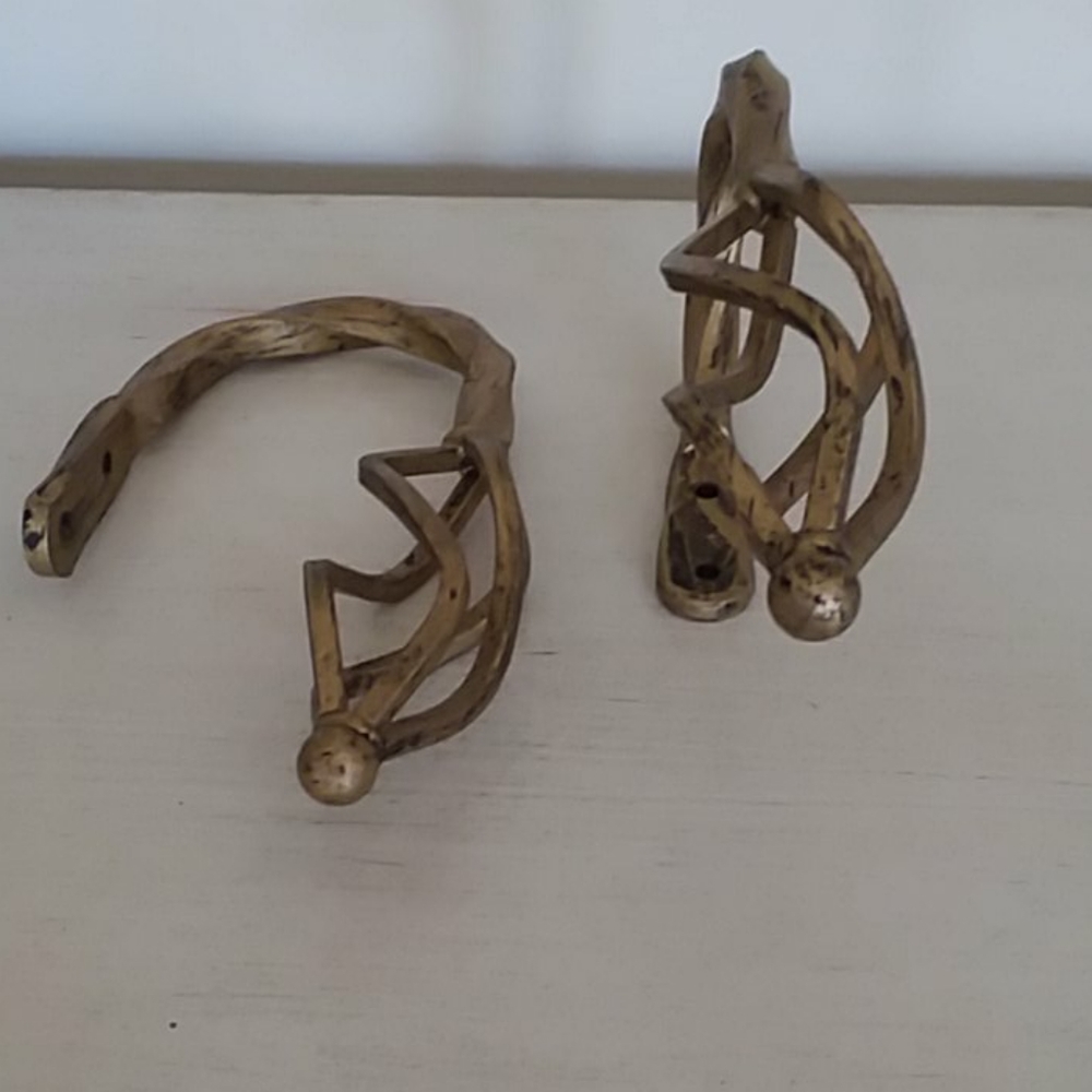 Pair of metal curtain tiebacks.